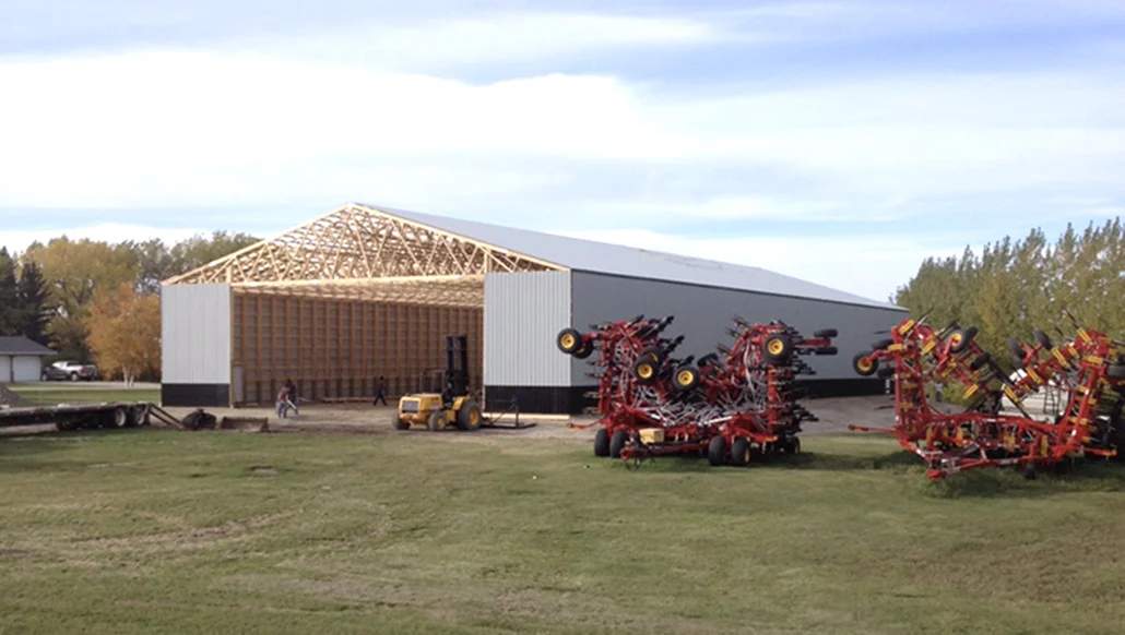In-progress post frame building using durable materials from Unrau Building Supply in Manitoba.